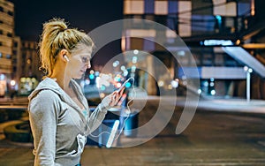 Young blonde sportswoman checking exercise progress on tracker mobile phone application