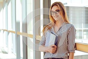 Young blonde student girl looking at camera. Woman in sunglasses in universuty. Education, training. Cool hipster student woman.