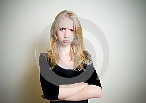 Young blonde woman angry and sullen portrait photo