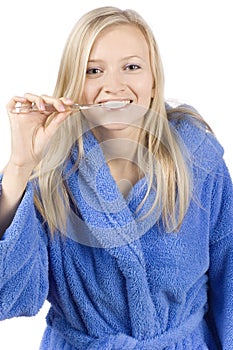 Young blonde woman brushing teeth