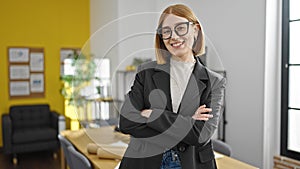 Young blonde woman business worker smiling confident standing with arms crossed gesture at office