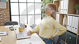 Young blonde woman business worker suffering for backache at office