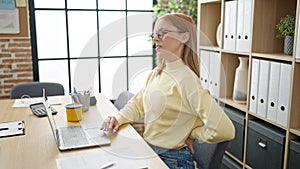 Young blonde woman business worker suffering for backache at office