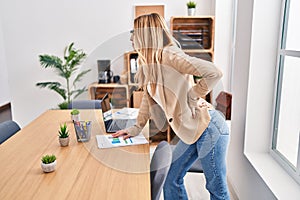 Young blonde woman business worker suffering for backache at office