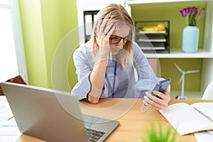 Young blonde woman business worker suffering for backache working at office