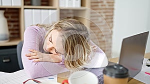 Young blonde woman business worker tired sleeping at office