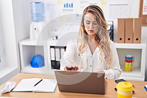 Young blonde woman busness worker using laptop working at office