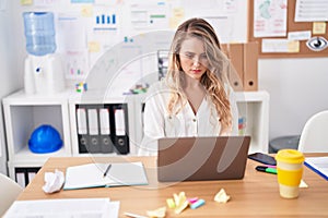 Young blonde woman busness worker using laptop working at office