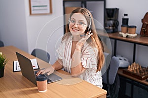 Young blonde woman call center agent smiling confident working at office