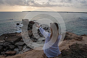 Young blonde woman in Calo d es Mort on the island of Formentera in Spain in summer 2021