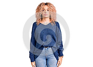 Young blonde woman with curly hair wearing casual winter sweater looking sleepy and tired, exhausted for fatigue and hangover,