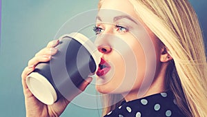 Young blonde woman drinking coffee