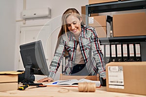 Young blonde woman ecommerce business worker smiling confident standing at office