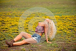 Young blonde woman in field