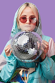 Beautiful lovely young Asian woman posing with silver discoball