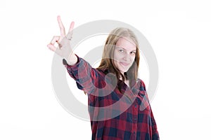Young blonde woman in isolated white background smiling with happy face make v fingers victory sign and Number two hand