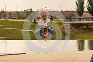 Young blonde woman jumping for joy