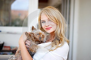 Young blonde woman with little dog