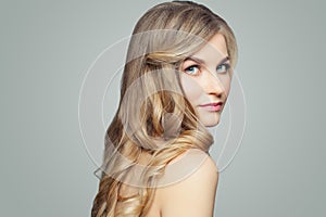 Young blonde woman with long healthy hair, spa beauty portrait