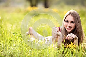 Young blonde woman on the meadow