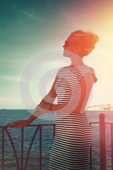 Young blonde woman at mediterranean sea looking away vintage