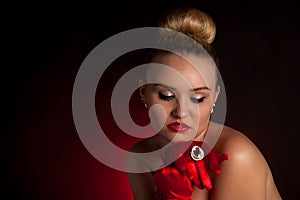 young blonde woman in red gloves and a big ring