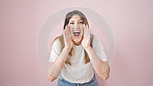 Young blonde woman screaming loudly over isolated pink background