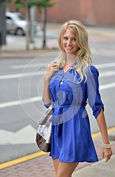 Young blonde woman shopping downtown
