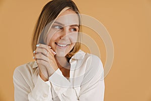 Young blonde woman smiling while looking aside