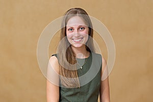 Young blonde woman smiling to the camera in studio