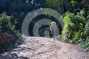 Young blonde woman in sportswear running cross-country through the mountains on a nature trail. Concept, running, trailrunning, photo