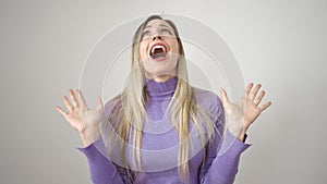 Young blonde woman standing with surprise expression over isolated white background