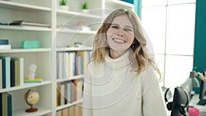 Young blonde woman student smiling confident standing at library university