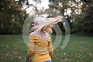 Young blonde woman turning around