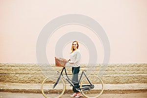 Young blonde woman on a vintage bicycle