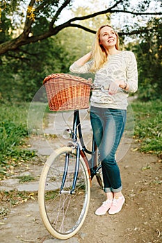 Young blonde woman on a vintage bicycle