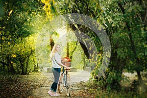 Young blonde woman on a vintage bicycle