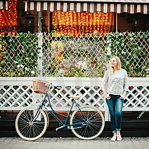 Young blonde woman on a vintage bicycle photo