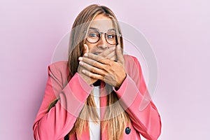 Young blonde woman wearing business style and glasses shocked covering mouth with hands for mistake