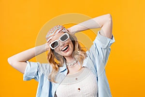 Young blonde woman wearing sunglasses smiling at camera