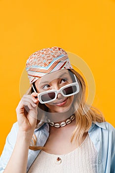 Young blonde woman wearing sunglasses smiling at camera