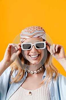 Young blonde woman wearing sunglasses smiling at camera