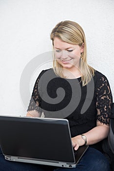 Young Blonde Woman Working on a Laptop