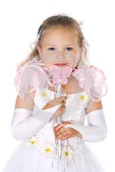 Young blue eyes girl in white dress holds magic wand with a butterfly