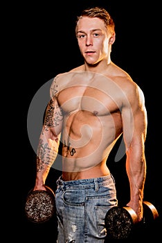 Young bodybuilder posing in jeans