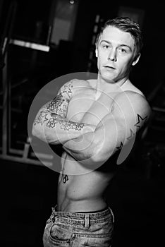 Young bodybuilder posing in jeans