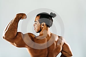 Young bodybuilder posing in studio