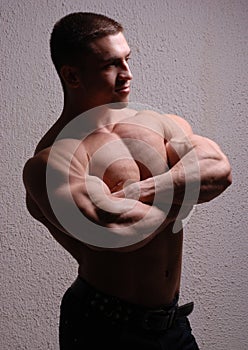 Young bodybuilder showing muscles