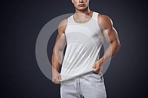 Young bodybuilder wearing white sleeveless t-shirt