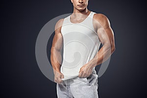 Young bodybuilder wearing white sleeveless t-shirt